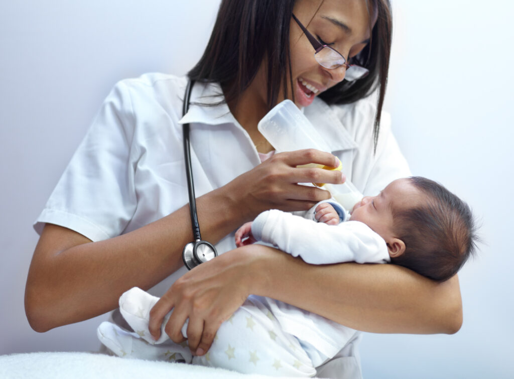 Shot of a healthcare worker giving formula to an infant who has a cleft palate.