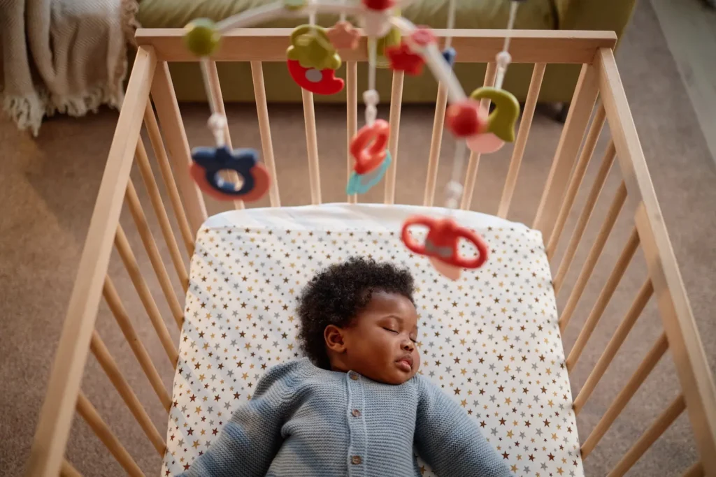 Baby sleeping peacefully on a firm, flat and uncluttered sleep surface
