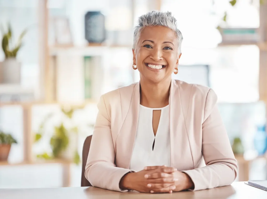Professional portrait of a woman representing postpartum and newborn care support